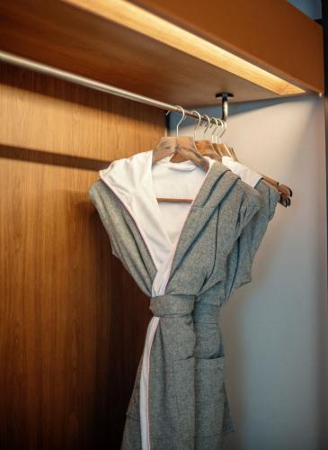 a robe hanging on a rack in a closet at UrCove By HYATT Chengdu Wenshu Monastery in Chengdu