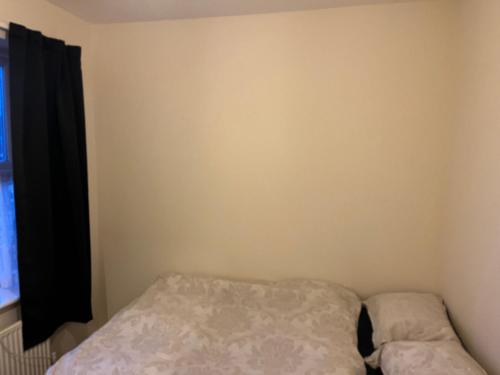 a small bedroom with a bed and a window at Jakes holiday inn in Stockton-on-Tees