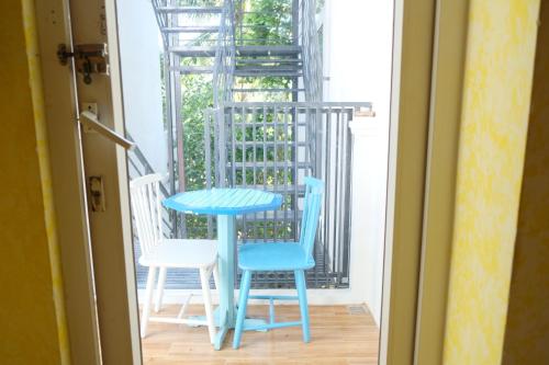 a blue table and two chairs on a balcony at La Marina Boutique Hotel & Spa in Mui Ne