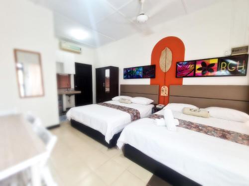 a hotel room with three beds in it at Bangi Guest House, Bangi Lama in Kajang