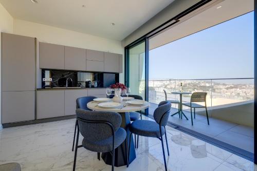 a kitchen and dining room with a table and chairs at Mercury Tower Apartments in St Julian's