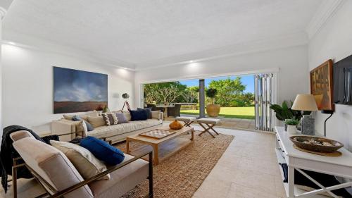 a living room with a couch and a table at Zephyr on Sapphire - Stunning private property on absolute beachfront in Sapphire Beach