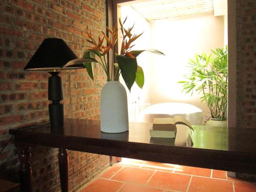 a table with a vase with plants on it at Ninh Binh Nature Homestay in Ninh Binh
