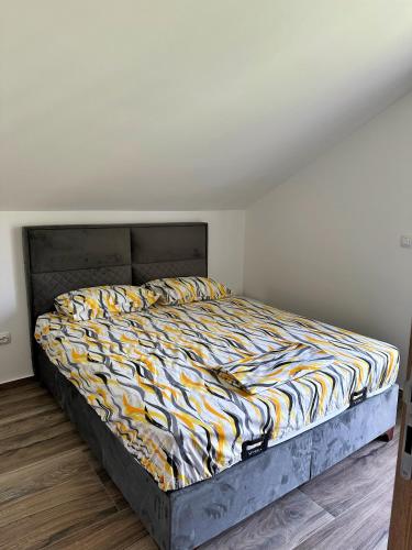 a large bed in a bedroom with a bedspread on it at Nirvana S in Tivat