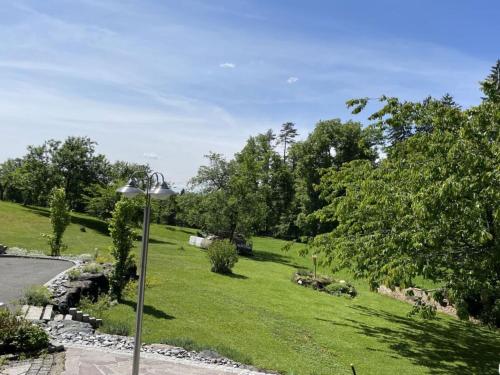 a park with green grass and a street light at Holiday home Styrian time in Stainz