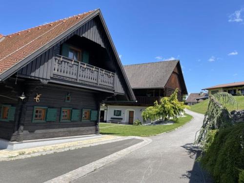 a wooden building with a balcony on the side of it at Holiday home Styrian time in Stainz