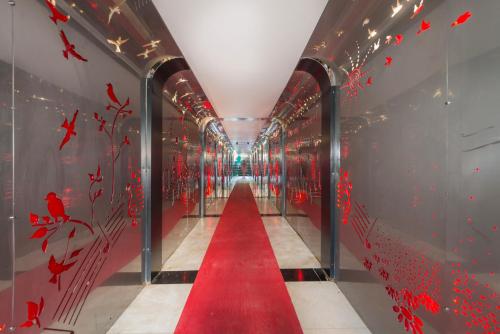 a red carpet path in a hallway with red butterflies at Grand Ring Hotel in Beldibi