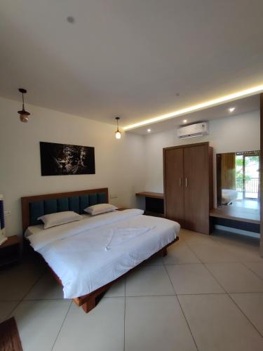 a large bedroom with a large bed in it at ExoticaHolidays in Sultan Bathery