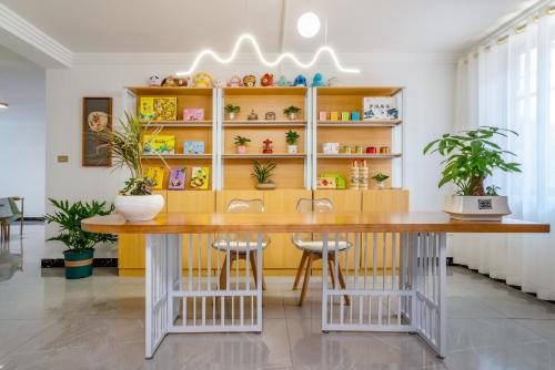 a dining room with a table and chairs at Fish House Youth Hostel in Guilin