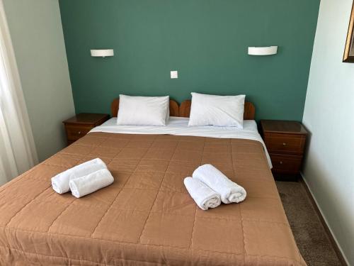 a bedroom with a bed with two towels on it at Anemos in Agia Triada