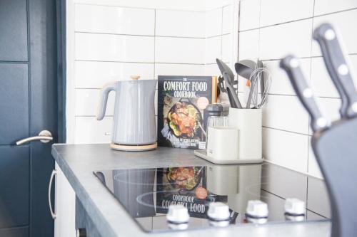 a kitchen counter with a sink in a kitchen at Stylish Home, hosted by ESONGRACE Stays, Stoke-on-Trent - Perfect for Families - Contractors - Holiday makers - Emergency Housing - Professionals, Relocators in Stoke on Trent