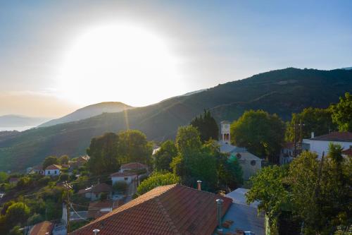 a view of a town with a mountain in the background at Mirabilia Mountain Villa with a sea view in Áyios Vlásios