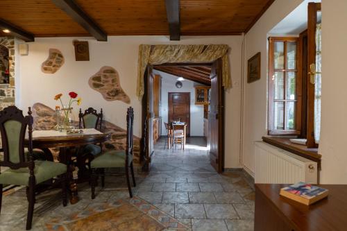 a kitchen and dining room with a table and chairs at Mirabilia Mountain Villa with a sea view in Áyios Vlásios