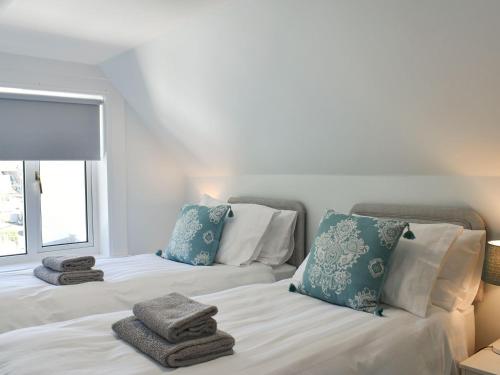two beds with towels on them in a bedroom at 1 Hamilton Terrace in Lamlash