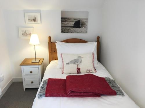 a bedroom with a bed with a bird on the pillow at The Apostles in Catacol