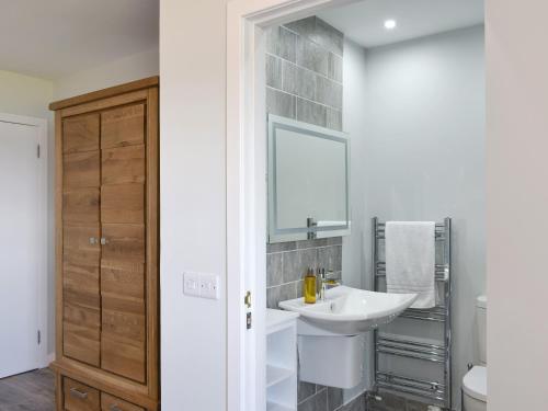 a bathroom with a sink and a mirror at Kinneil Land in Lamlash