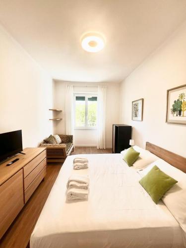 a large bedroom with two beds and a television at Doria home-Saint Peter's View in Rome