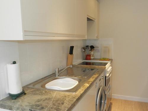 a kitchen with a sink and a counter top at Hamilton Terrace in Lamlash