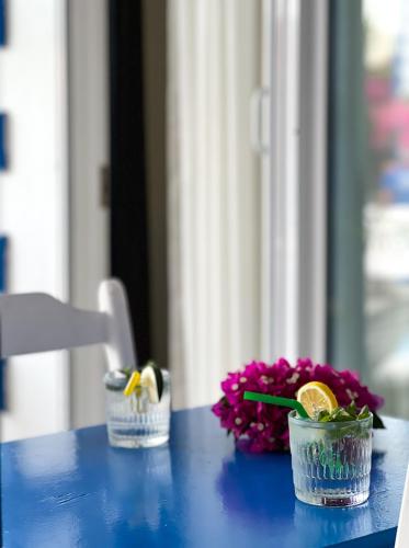 a blue table with two small glass jars and flowers at Pineloft Selimiye in Mugla