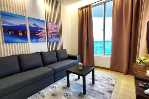 a living room with a couch and a table at The Wave - 3R3BR Duplex Penthouse l 10 Pax l Near Jonker l A23A15 in Melaka