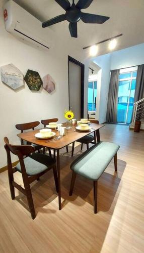 a dining room with a table and chairs and a ceiling fan at The Wave - 3R3BR Duplex Penthouse l 10 Pax l Near Jonker l A23A15 in Melaka