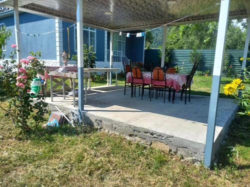 a patio with a table and chairs on it at Qəbələ Lux Home in Bum