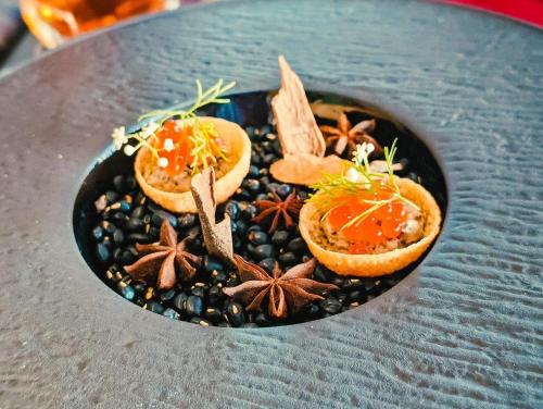 a plate of food with spices on a table at Hanoi Tirant Hotel in Hanoi