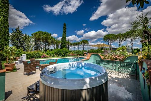 a hot tub in the middle of a patio at Villa dei Pavoni - Holiday Villa in Montauto