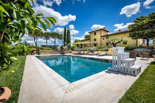 a swimming pool in the backyard of a house at Villa dei Pavoni - Holiday Villa in Montauto