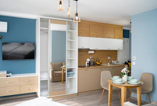 a kitchen and a living room with a table and chairs at Ivalena APART in Kranevo