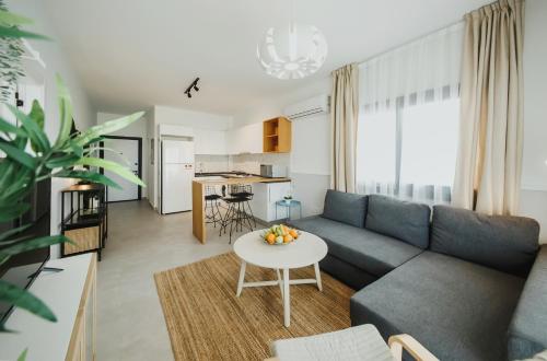 a living room with a couch and a table at Caesar Blue Seaside Luxury Apartments in Kalecik