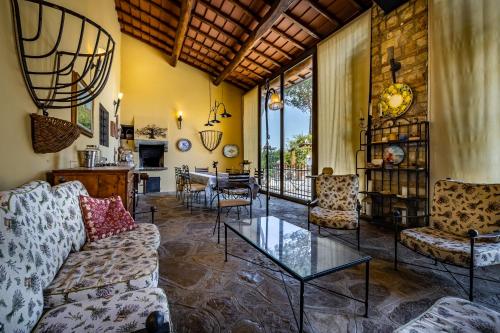 a living room with a couch and a table at Villa dei Pavoni - Holiday Villa in Montauto
