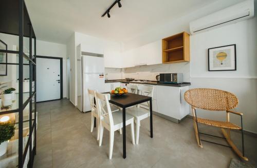 a kitchen and dining room with a table and chairs at Caesar Blue Seaside Luxury Apartments in Kalecik