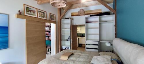 a small bedroom with a bed and a closet at Tres belle maison en bois,dans la Marina, 10pers, au bord de leau in Lacanau