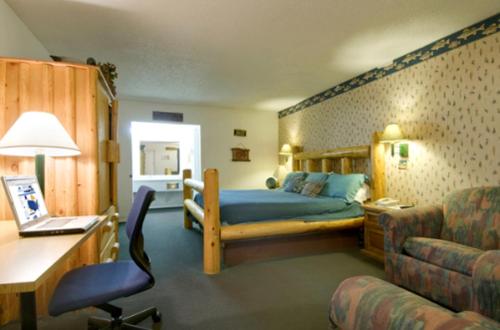 a bedroom with a bed and a desk and a chair at Five Star Inn Burleson in Burleson