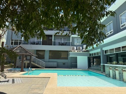 an apartment building with a swimming pool in front of it at Circle Inn - Iloilo City Center in Iloilo City