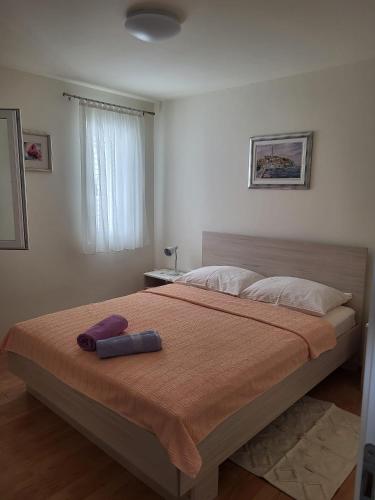 a bedroom with a large bed with two pillows on it at Krznar - Stari grad Pag in Pag
