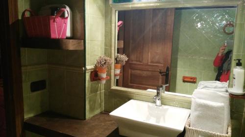 La salle de bains est pourvue d'un lavabo et d'un miroir. dans l'établissement Apartamentos Anateresa, à Mogarraz