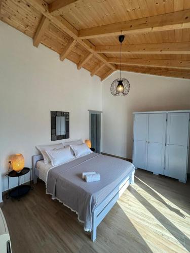 a bedroom with a large bed and a wooden ceiling at House Yara Dalmatia in Kruševo