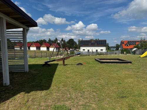 a playground with a slide in a field at Jaśminowy Sad in Mikołajki
