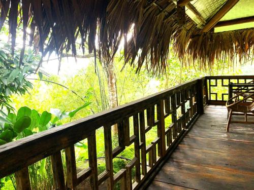 a porch of a resort with a table and chairs at Pu Luong Cuisine Garden Homestay in Làng Bang