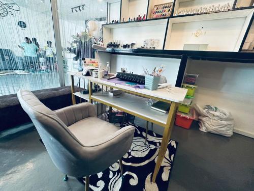 an office with a desk and a chair and a keyboard at Kuu Inn Hotel in Arau