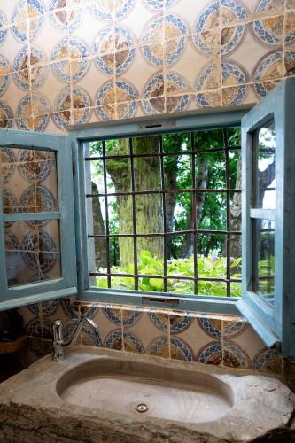 a bathroom with a sink and two windows at La Casa sul Forte in Seravezza