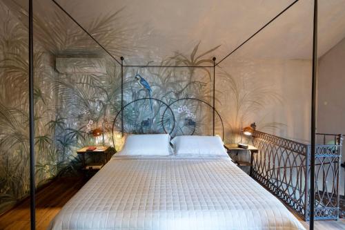 a bedroom with a large bed with a mural at La Casa sul Forte in Seravezza