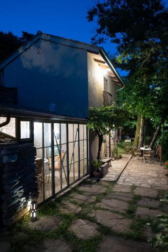 a house with a blue roof and a patio at La Casa sul Forte in Seravezza