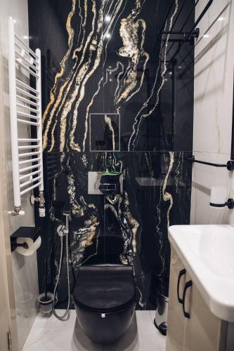 a bathroom with a black and gold wallpaper at Luxurious House with Deluxe rooms & Free Secured Parking in Sofia