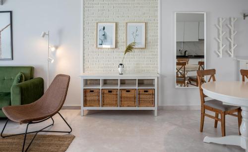 a living room with a table and chairs at Caesar Blue Seaside Luxury Apartments in Kalecik