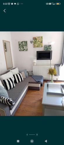 a living room with a couch and a table at Kawalerka pod jabłonią in Wielki Kack