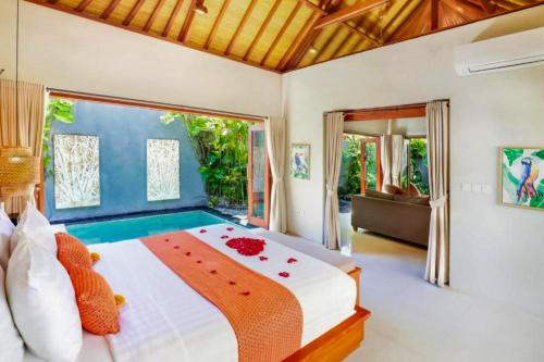Un dormitorio con una cama grande con flores. en Sadawira 1 BR Private Pool Villa & Bathtub ZN168, en Legian