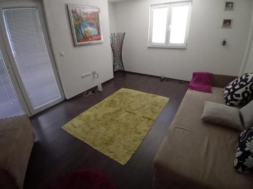 a living room with a couch and a rug at MEDINA in Sarajevo
